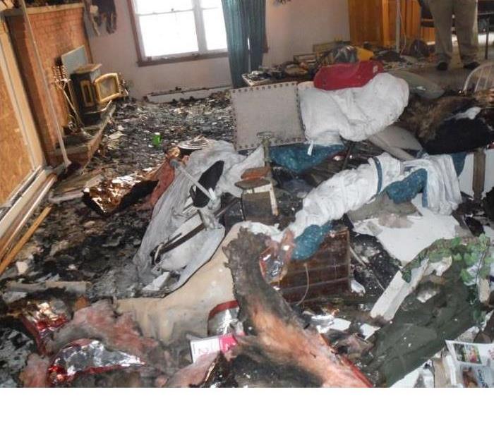 Fire ravaged contents and debris in a living room