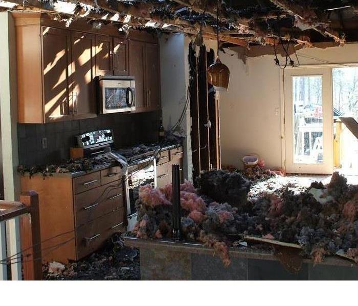 fire raveged kitchen with heavy smoke damage