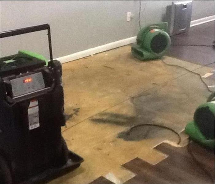 drying equipment placed on a half removed laminate floor