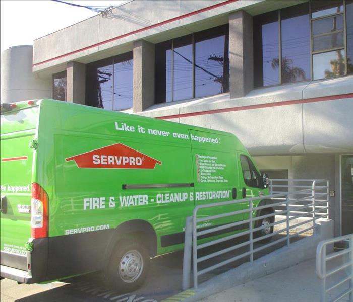 Servpro green van parked infront of a two story commercial building